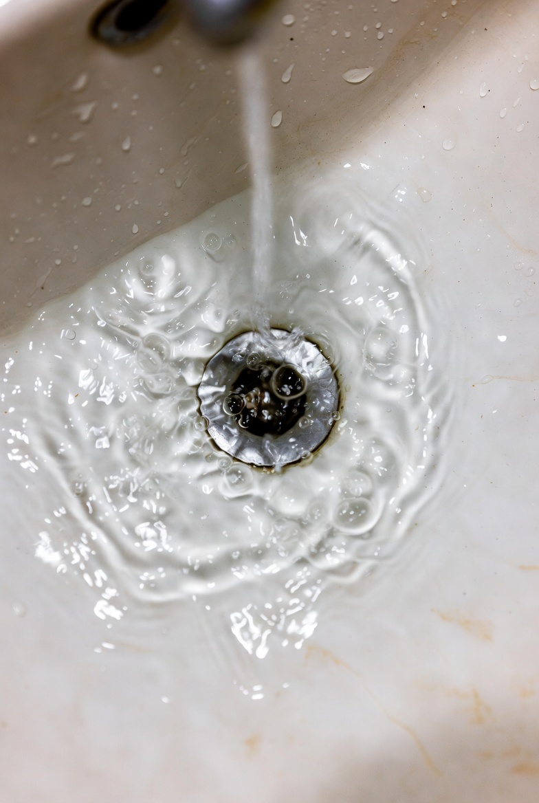 Air bubbles rising in bathroom sink drain