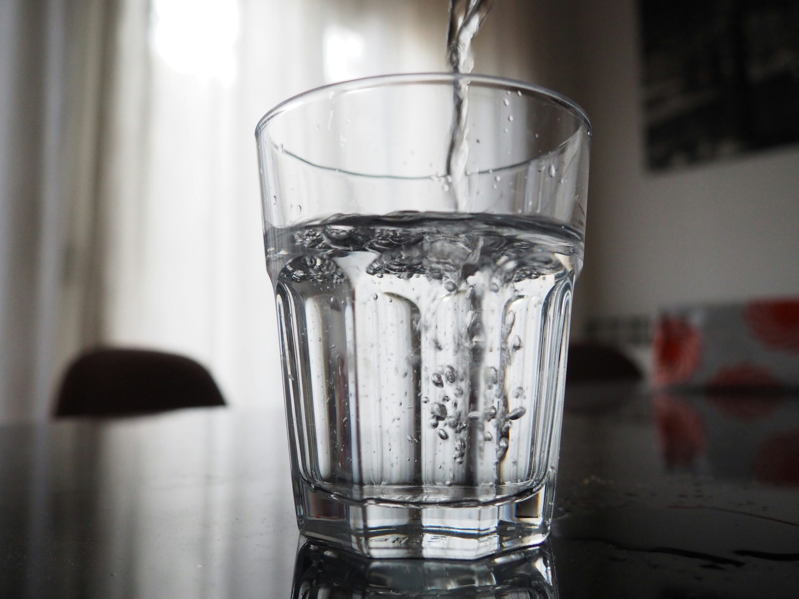 A clear glass of tap water on a kitchen counter
